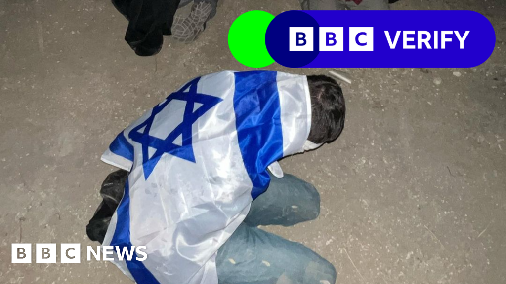 Palestinian detainee is pictured with an Israeli flag draped over their back