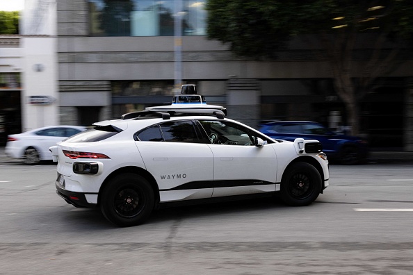 A Waymo autonomous vehicle turns onto Mission Street in San Francisco, on November 17, 2023. (Photo by JASON HENRY/AFP via Getty Images)