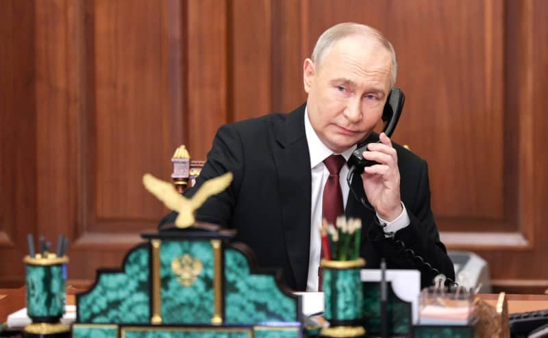 Russian President Vladimir Putin talks on the phone before his inauguration ceremony as President of the Russian Federation in the Kremlin. -/Kremlin/dpa