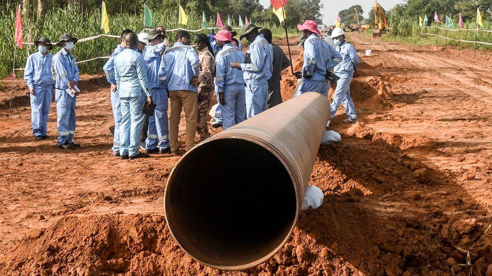 Workers from Niger and China are seen on the construction site of an oil pipeline in the region of Gaya, Niger - October 2022