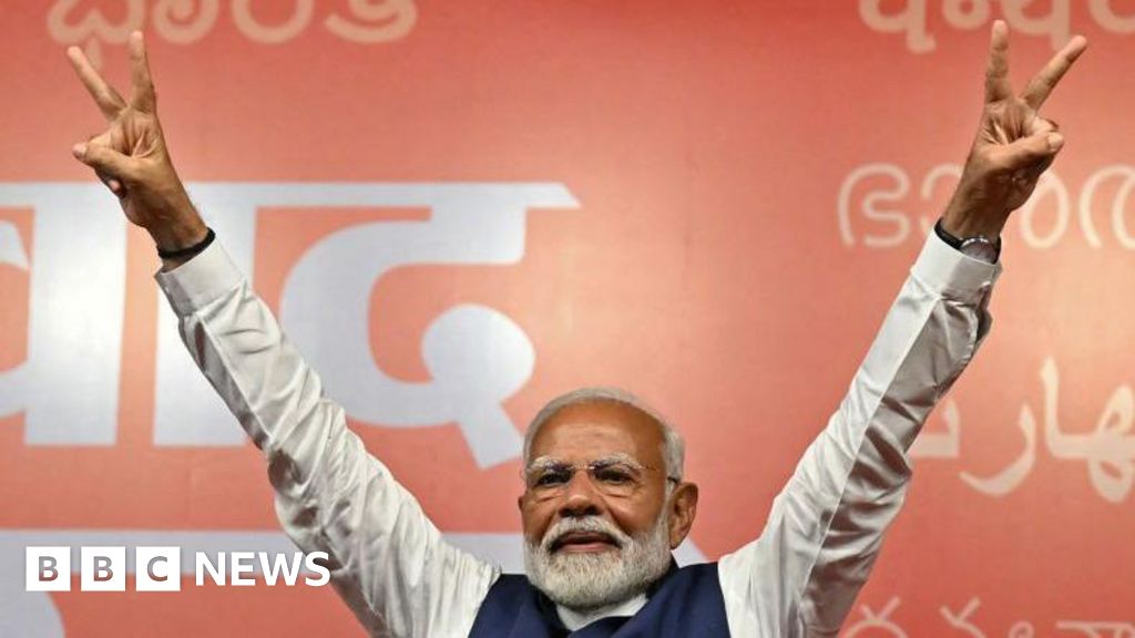 Modi claims victory as he heads for reduced majority