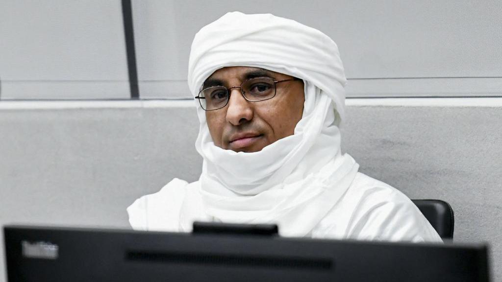 Al Hassan Ag Abdoul Aziz Ag Mohamed Ag Mahmoud sitting in the ICC courtroom