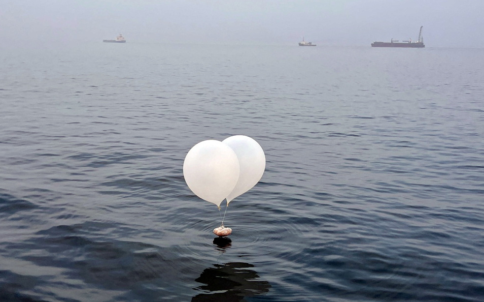 A balloon carrying various objects including what appeared to be trash, believed to have been sent by North Korea, is pictured at the sea off Incheon, South Korea