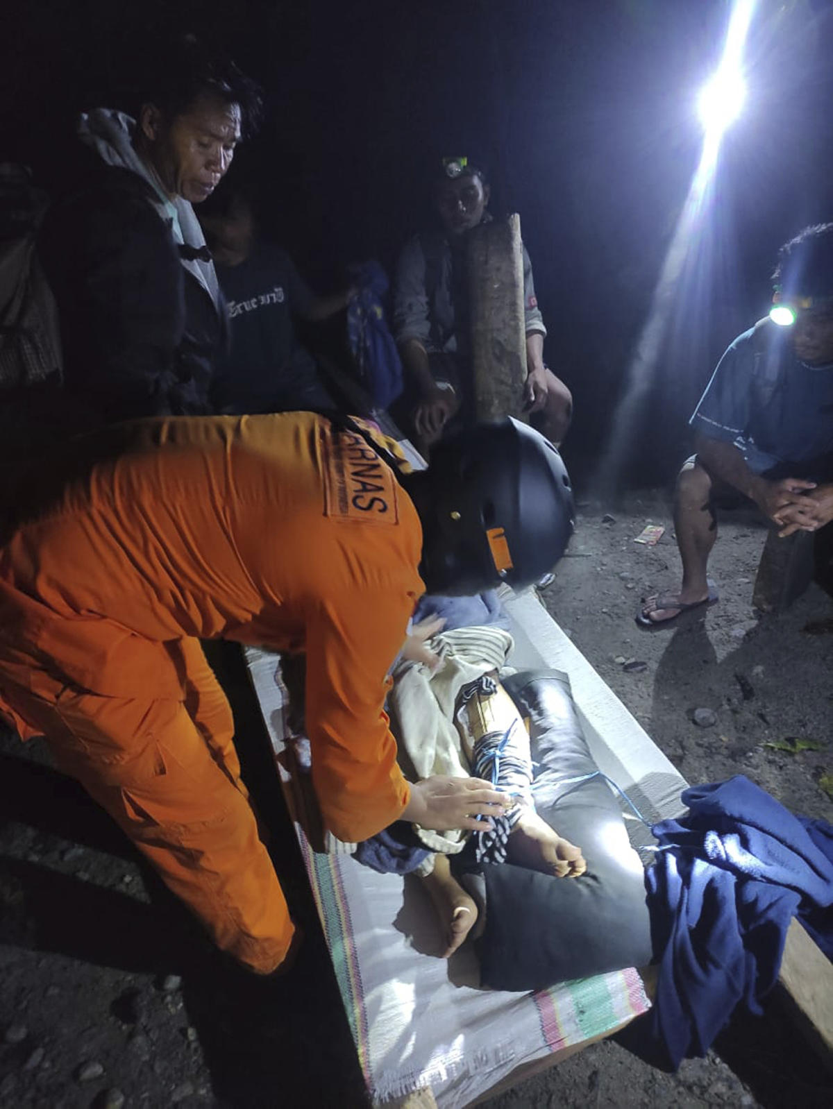 Rescuers search for dozens buried in an Indonesian landslide that killed at least 17 people