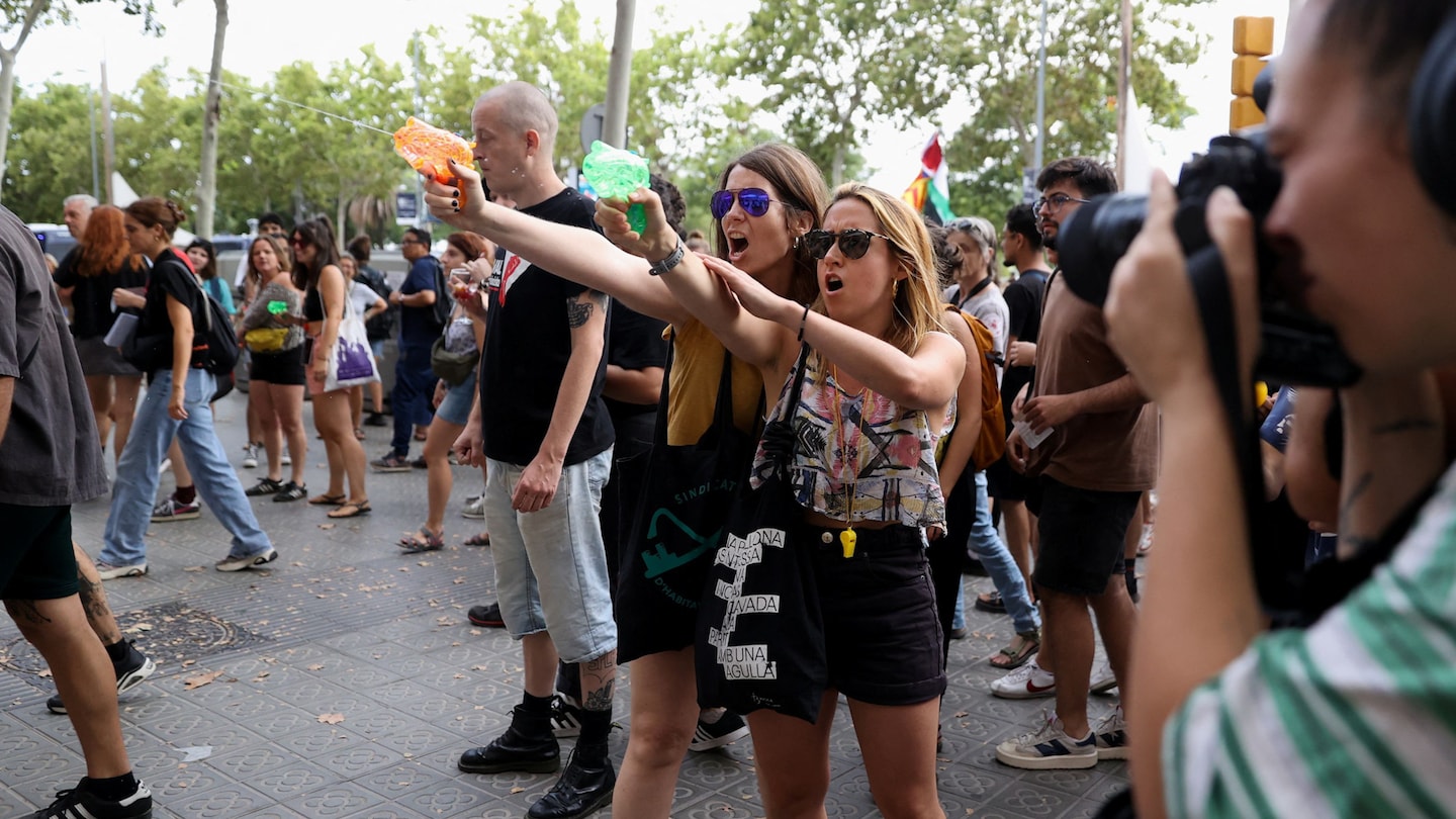 Barcelona anti-tourism protesters spray visitors with water guns