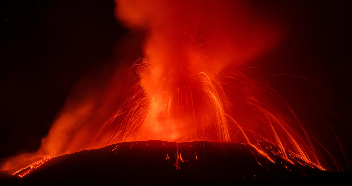 Photos show Mount Etna spewing hot lava into the air as Italian volcano erupts again