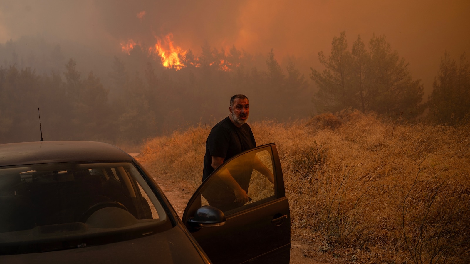 Wildfire spreads near Athens amid scorching heat, prompting evacuations