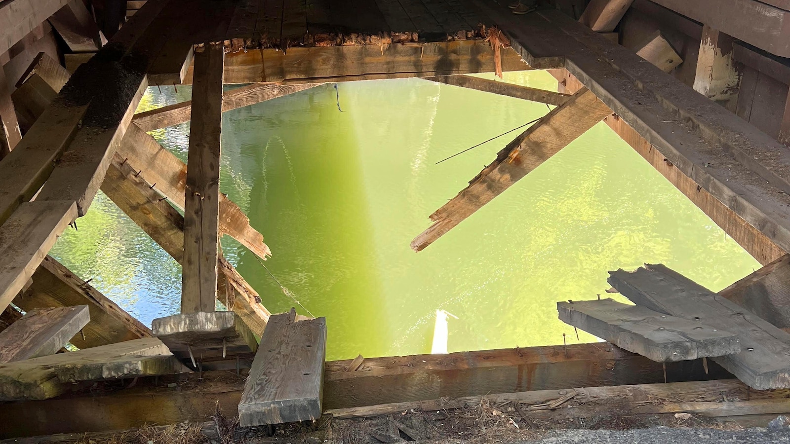 Dump truck leaves hole in covered bridge when it crashes into river in Maine