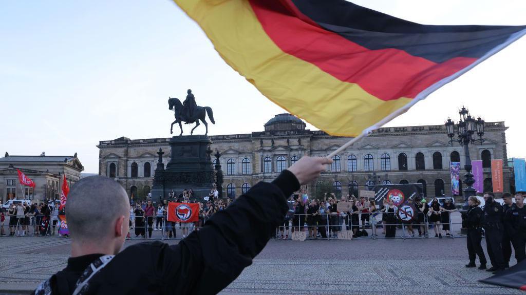 A supporter of the far-right AFD group taunts anti-fascist protesters