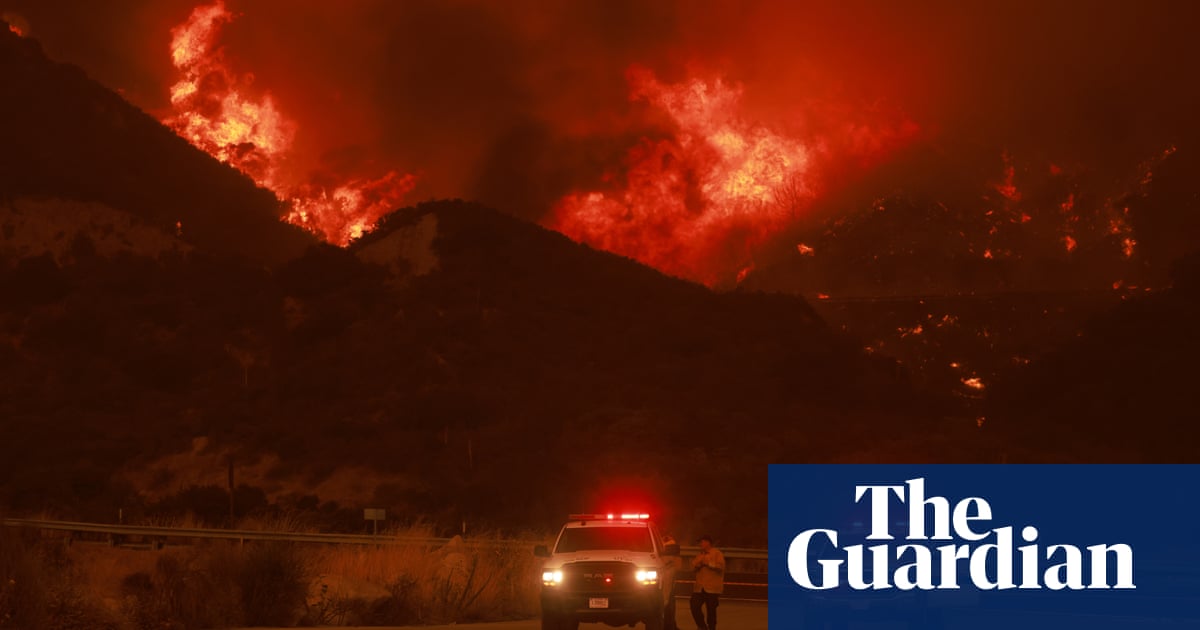 Wildfire near LA forces evacuations and threatens tens of thousands of buildings | California