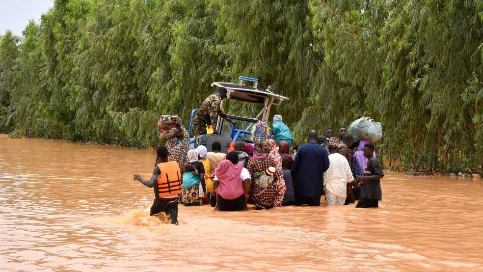 An image of people wading through water in Niger