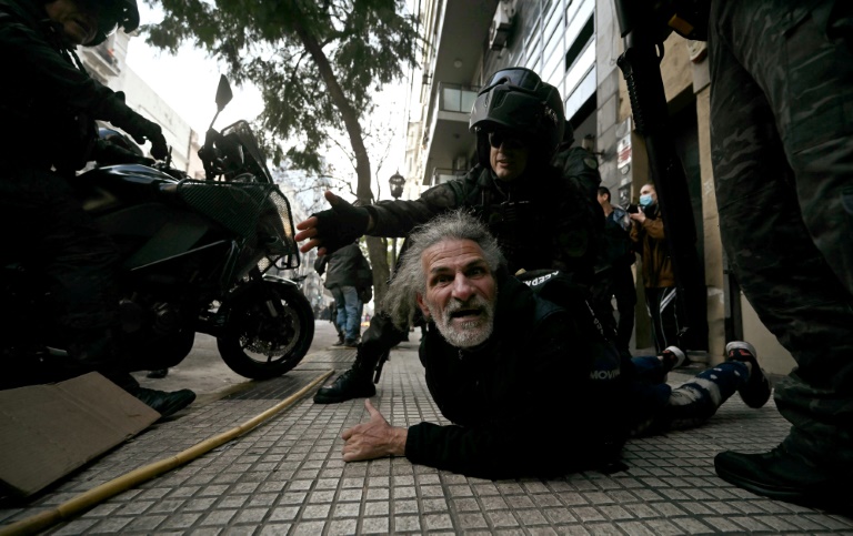 An elderly man is detained by riot police during a protest outside the National Congress in Buenos Aires on September 11, 2024 (Luis ROBAYO)