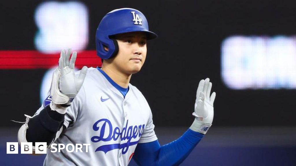 Shohei Ohtani of the Los Angeles Dodgers reacts after hitting a double against the Miami Marlins