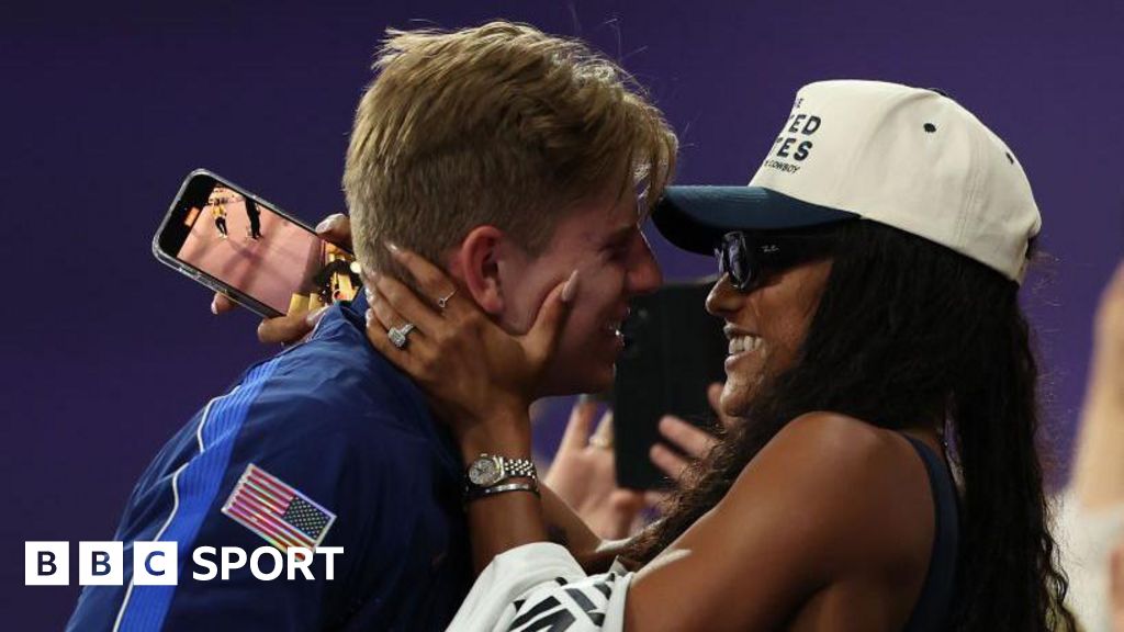 Hunter Woodhall hugging his wife Tara Davis-Woodhall after winning Paralympic gold