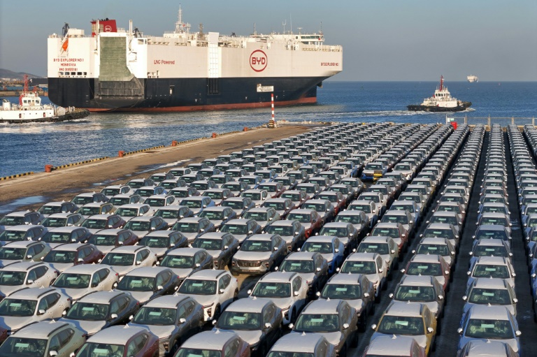 Chinese electric cars, like these waiting to be shipped for export, are at centre of trade tensions with the EU (-)