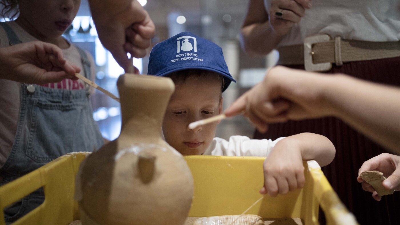 Israeli boy who broke an ancient jar learns how the museum is piecing it back together : NPR