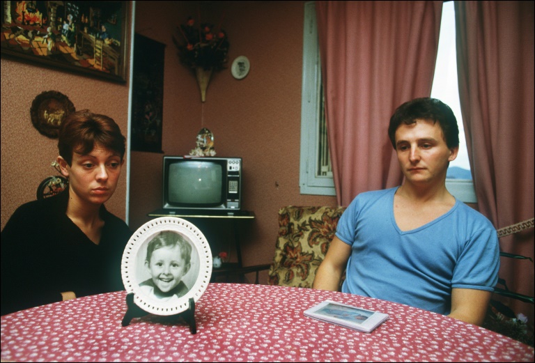 Christine and Jean-Marie Villemin at home with a picture of Gregory, a month after his death (ERIC FEFERBERG)