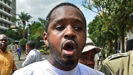 Kenyan activist Boniface Mwangi is arrested during a demonstration against Members of Parliament who have demanded higher wages, outside Pariliament in Nairobi on 16 May 2013