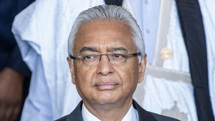 A close-up shot of Pravind Jugnauth. He has grey hair and is wearing glasses.