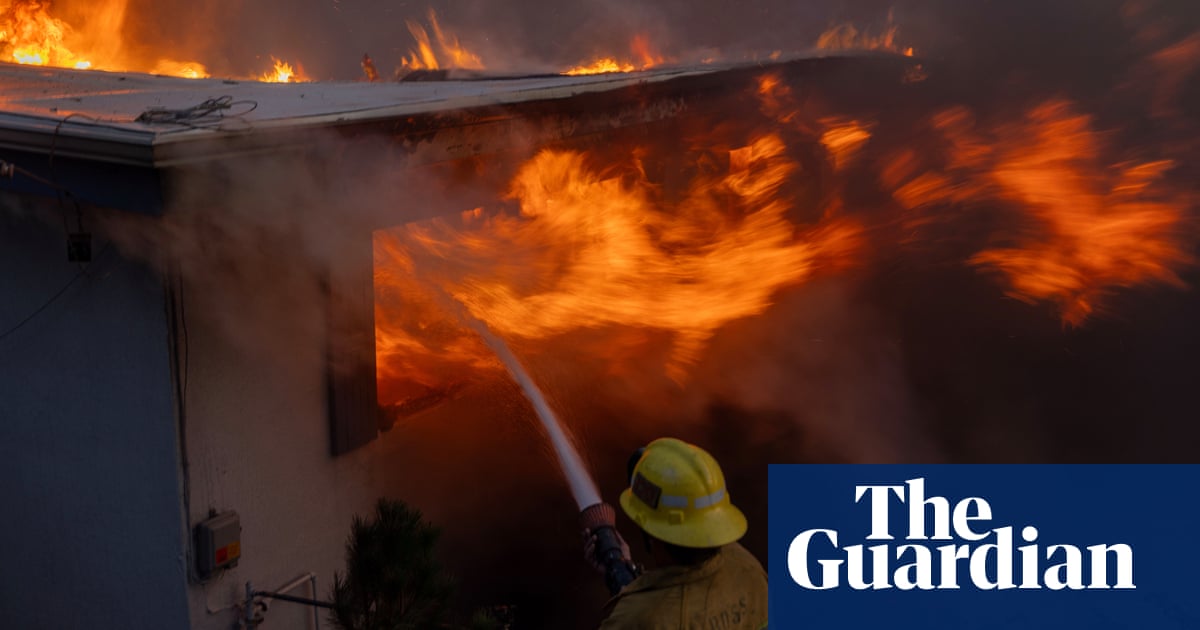 Wind-driven wildfire rages in California with scores of homes charred | California