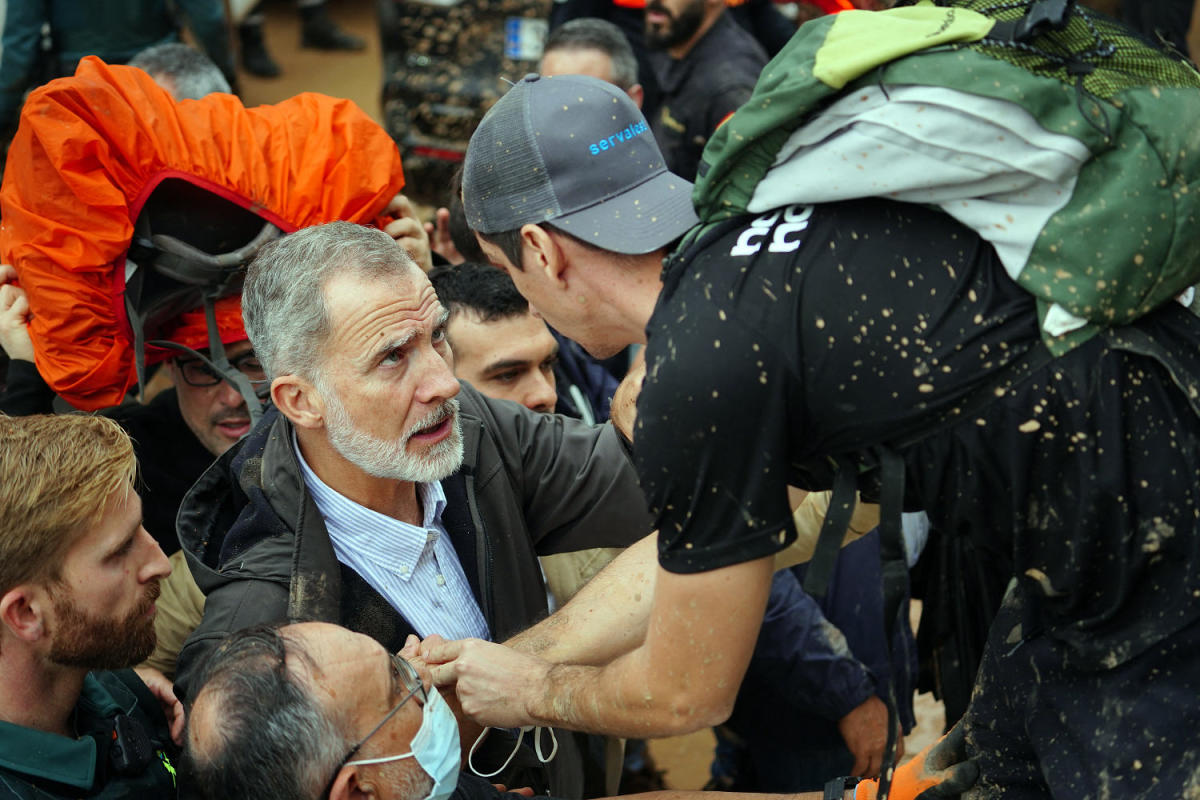 Angry crowds throw mud and shout insults at Spanish king as he tours flood damage