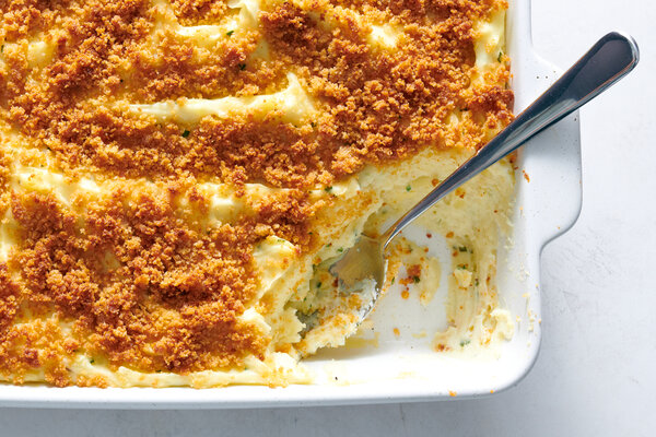 An overhead image of a baking pan full of mashed potatoes topped with bread crumbs.