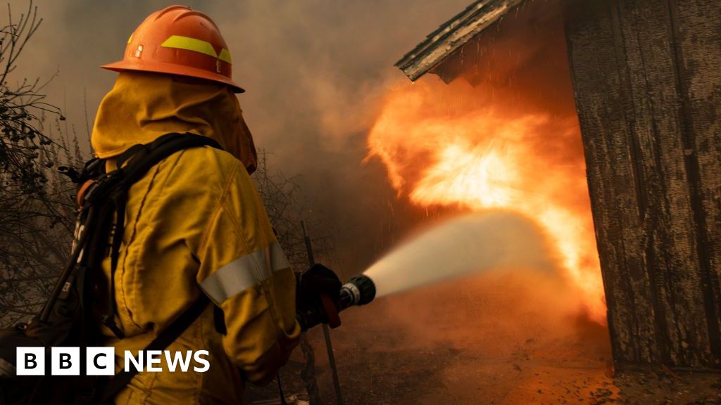 Thousands flee as strong winds fuel flames