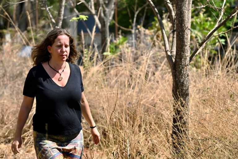 Isabel Schmidt, a Brazilian professor, researcher and Cerrado restoration expert, walks in a Cerrado garden at Brasilia