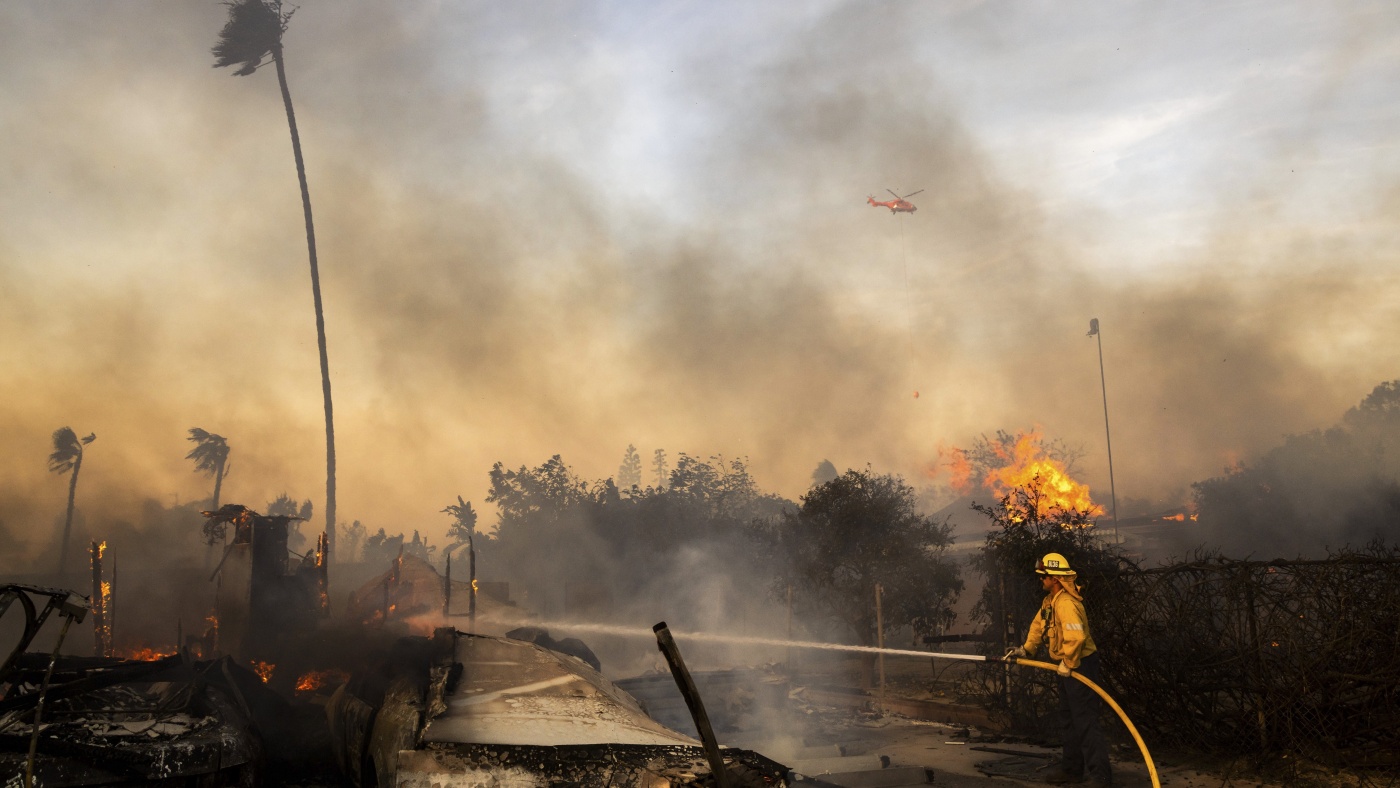 Slower winds aid firefighters battling destructive blaze in Southern California : NPR